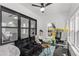 Bright sunroom with black marble floors, lots of windows, a ceiling fan, and modern décor at 645 Cumberland Rd, Atlanta, GA 30306