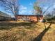 A spacious backyard features a deck, grassy area, and mature trees, perfect for outdoor living at 773 Cone Rd, Forest Park, GA 30297