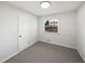 An empty bedroom with neutral colored walls and carpet at 773 Cone Rd, Forest Park, GA 30297