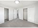 A bedroom showcases two closets, neutral colored walls and carpet flooring at 773 Cone Rd, Forest Park, GA 30297