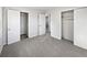 An empty bedroom features two closets with carpet flooring at 773 Cone Rd, Forest Park, GA 30297