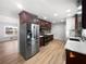 A kitchen showcases stainless steel appliances, wood cabinets and countertops with modern lighting and light wood flooring at 773 Cone Rd, Forest Park, GA 30297