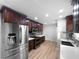 Modern kitchen with stainless steel appliances, dark wood cabinets, and light countertops at 773 Cone Rd, Forest Park, GA 30297