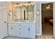 Bright bathroom featuring double vanity, framed mirror, and a glass shower at 91 Reynoldston Ct, Suwanee, GA 30024