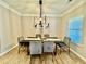 Dining room with wood floors and contemporary lighting fixtures at 91 Reynoldston Ct, Suwanee, GA 30024