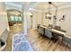 Bright dining room featuring wood flooring, modern lighting, and open floorplan at 91 Reynoldston Ct, Suwanee, GA 30024