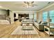 Open-concept living room showcasing hardwood flooring and staircase at 91 Reynoldston Ct, Suwanee, GA 30024