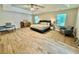 Spacious main bedroom with ceiling fan, wood floors and large windows at 91 Reynoldston Ct, Suwanee, GA 30024