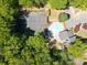 Aerial view showcasing tennis courts, a pool, mature landscaping, and parking at 2064 Powers Ferry Se Trce, Marietta, GA 30067