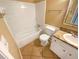 Bathroom featuring white tile, a bathtub with shower, and a vanity with countertop at 2064 Powers Ferry Se Trce, Marietta, GA 30067