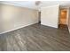 Spacious bedroom featuring wood flooring, neutral walls, and a doorway leading to an ensuite bathroom at 2064 Powers Ferry Se Trce, Marietta, GA 30067