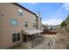 A view of the home's rear exterior with a brick paver patio and covered seating area at 2268 Austin Common Way, Dacula, GA 30019