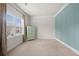 Cozy bedroom with wainscoting detail, a green armoire and a view from the bright window at 2268 Austin Common Way, Dacula, GA 30019