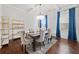 Dining room with an elegant light fixture, a table set for dinner, and large window at 2268 Austin Common Way, Dacula, GA 30019