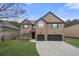 Two-story brick home with a two-car garage and well-manicured lawn at 2268 Austin Common Way, Dacula, GA 30019