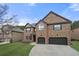 Elegant brick home featuring a two-car garage and well-maintained landscaping at 2268 Austin Common Way, Dacula, GA 30019