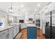 Bright kitchen featuring stainless appliances, granite counters, and blue kitchen island at 2268 Austin Common Way, Dacula, GA 30019