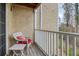 Cozy balcony features wooden floors, seating, and a white railing with wooded views at 3140 Seven Pines Ct # 202, Atlanta, GA 30339