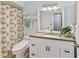 Bathroom featuring a modern vanity, a leaf-patterned shower curtain, and lots of natural light at 3140 Seven Pines Ct # 202, Vinings, GA 30339