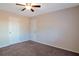 Simple bedroom with plush carpet, bright windows, and a ceiling fan at 4676 Cedar Park Trl, Stone Mountain, GA 30083