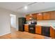 Kitchen view with wood cabinets and black appliances at 4676 Cedar Park Trl, Stone Mountain, GA 30083