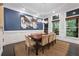 Bright dining room featuring large windows, wainscoting, and modern light fixture at 5964 Reddington Way, Sandy Springs, GA 30328