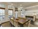 Dining room adjacent to kitchen featuring large windows, stylish light fixture, and seating for eight at 5964 Reddington Way, Sandy Springs, GA 30328