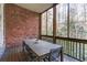 Enclosed porch with wood flooring and brick wall at 5964 Reddington Way, Sandy Springs, GA 30328