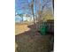 Backyard featuring some trees and green grass at 6424 W Charter Way, Lithonia, GA 30058