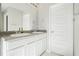 Bathroom with double vanity, large mirror, and abundant cabinet storage at 11997 Lovejoy Crossing Way, Hampton, GA 30228