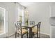 Bright dining area with modern table, seating, decorative light fixture and natural light at 11997 Lovejoy Crossing Way, Hampton, GA 30228