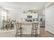 Bright kitchen with granite countertops, stainless steel appliances, and a dining area with a decorative light fixture at 11997 Lovejoy Crossing Way, Hampton, GA 30228