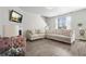 Inviting living room with neutral tones, fireplace, mounted television, and lots of natural light at 11997 Lovejoy Crossing Way, Hampton, GA 30228