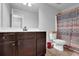 Bathroom featuring vanity, large mirror, and a shower with patterned shower curtain at 48 Scenic Ovlk, Acworth, GA 30101