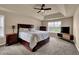 Relaxing bedroom with soft tones, a tray ceiling, a ceiling fan, and a large window at 48 Scenic Ovlk, Acworth, GA 30101