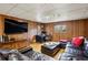 Finished basement featuring wood paneling, recessed lighting, and entertainment center at 1605 Saint Tropez Way, Atlanta, GA 30350