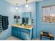Bright bathroom featuring a blue vanity with double sinks at 1605 Saint Tropez Way, Atlanta, GA 30350