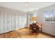 Bedroom showcasing hardwood floors, ample closet space, and a window near a writing desk at 1605 Saint Tropez Way, Atlanta, GA 30350