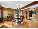 Elegant dining room with hardwood floors, wood paneling, and a chandelier at 1605 Saint Tropez Way, Atlanta, GA 30350