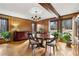 Formal dining room featuring wood paneling, hardwood floors, and large windows at 1605 Saint Tropez Way, Atlanta, GA 30350