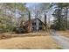 Charming brick home with blue door, surrounded by mature trees and a well-manicured lawn at 1605 Saint Tropez Way, Atlanta, GA 30350