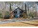 Charming brick home with blue door, surrounded by mature trees and a well-manicured lawn at 1605 Saint Tropez Way, Atlanta, GA 30350