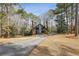 Exterior view of the home, showcasing the driveway and front yard with mature trees at 1605 Saint Tropez Way, Atlanta, GA 30350
