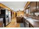 Traditional style kitchen with wood paneling, stainless steel appliances, and hardwood floors at 1605 Saint Tropez Way, Atlanta, GA 30350