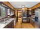 A bright kitchen featuring stainless steel appliances, wood paneling, and hardwood floors at 1605 Saint Tropez Way, Atlanta, GA 30350