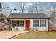 Charming home featuring a bright red front door and a well-maintained front yard at 2930 Lemans St, Cumming, GA 30041