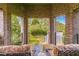 Inviting covered brick balcony with comfortable seating and views of lush greenery at 3631 Habersham Nw Rd, Atlanta, GA 30305