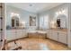 Bright bathroom featuring dual vanities, a soaking tub, and tile flooring at 3631 Habersham Nw Rd, Atlanta, GA 30305