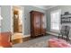Bedroom featuring large wooden armoire, hardwood floors, patterned rug and access to ensuite bathroom at 3631 Habersham Nw Rd, Atlanta, GA 30305