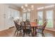 Charming breakfast nook with wood table, elegant chandelier, and bright windows with shutters at 3631 Habersham Nw Rd, Atlanta, GA 30305